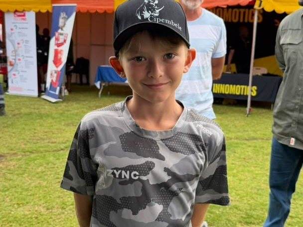 A young visitor wearing a Cipembele cap at the MTE Kansanshi expo